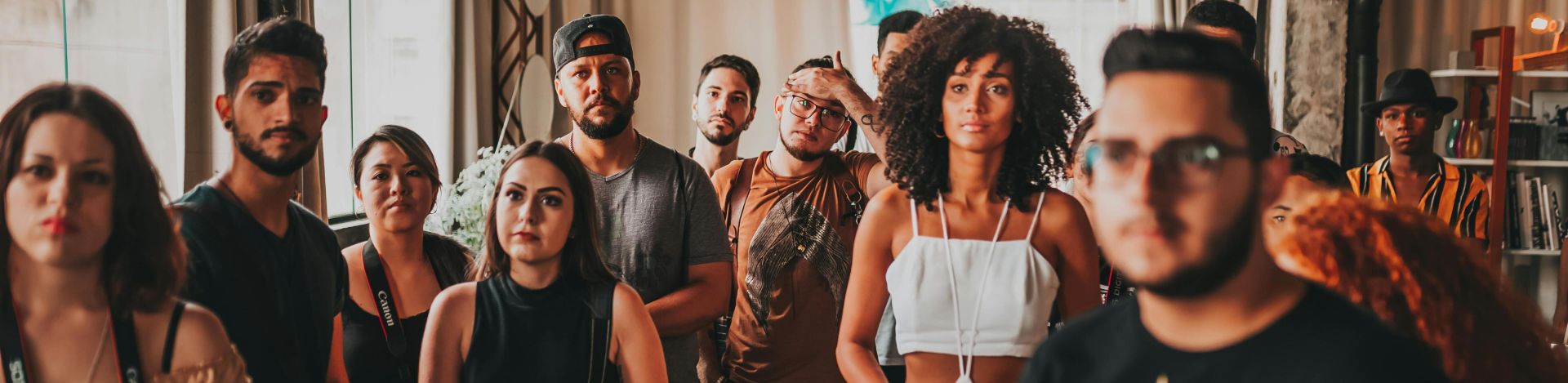 Vibrant and diverse group gathering at an indoor event in São Paulo, fostering interaction and collaboration.